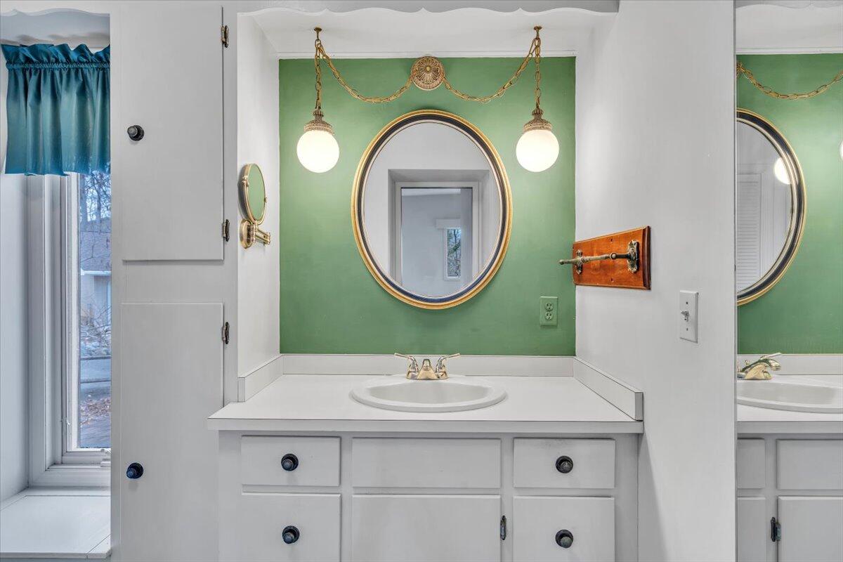 2768 Lake Retreat Road Huddleston, VA 24104 - Photo 42 of 92 a bathroom with a sink mirror and toilet