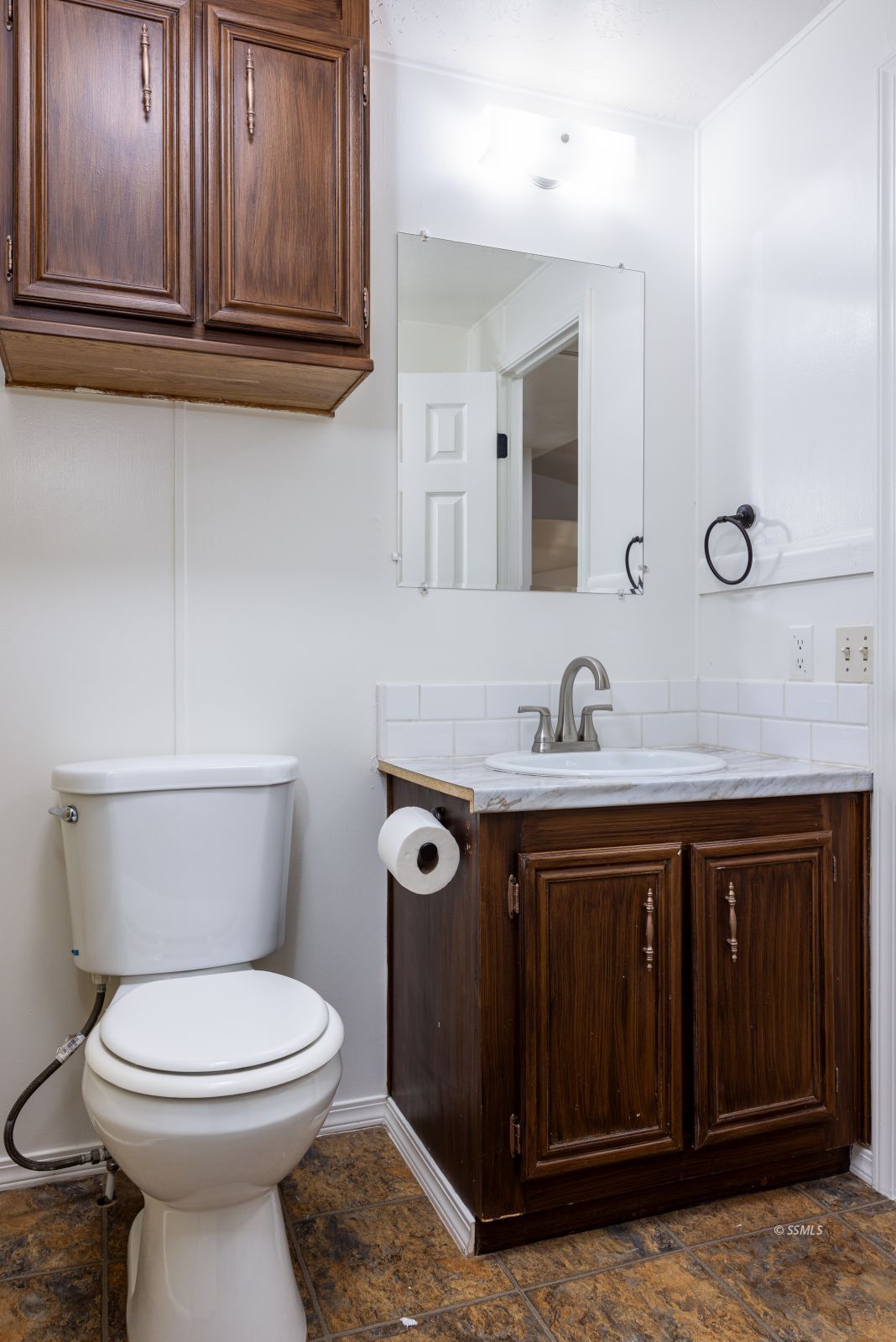 828 North Victor Street Ridgecrest, CA 93555 - Photo 26 of 50 a bathroom with a toilet sink and mirror