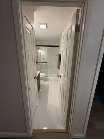 a bathroom with a granite countertop sink a toilet and a shower