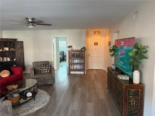 a living room with furniture and a potted plant