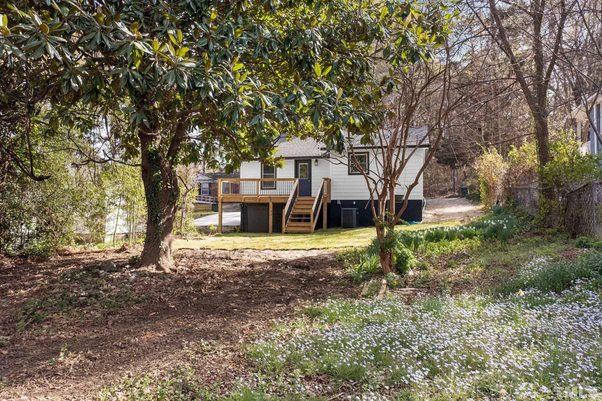 2908 Woods Place Raleigh, NC 27607 - Photo 12 of 38 a view of a house with backyard and tree