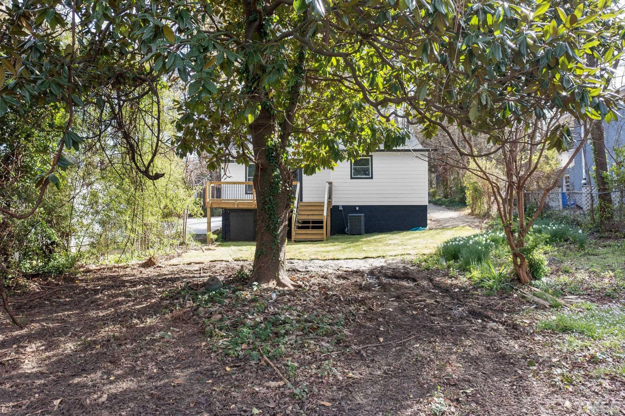 2908 Woods Place Raleigh, NC 27607 - Photo 13 of 38 a house is sitting in middle of the forest