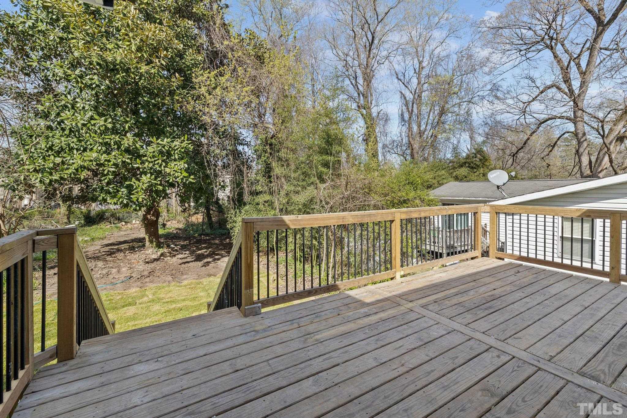 2908 Woods Place Raleigh, NC 27607 - Photo 18 of 38 a view of balcony with wooden floor and fence