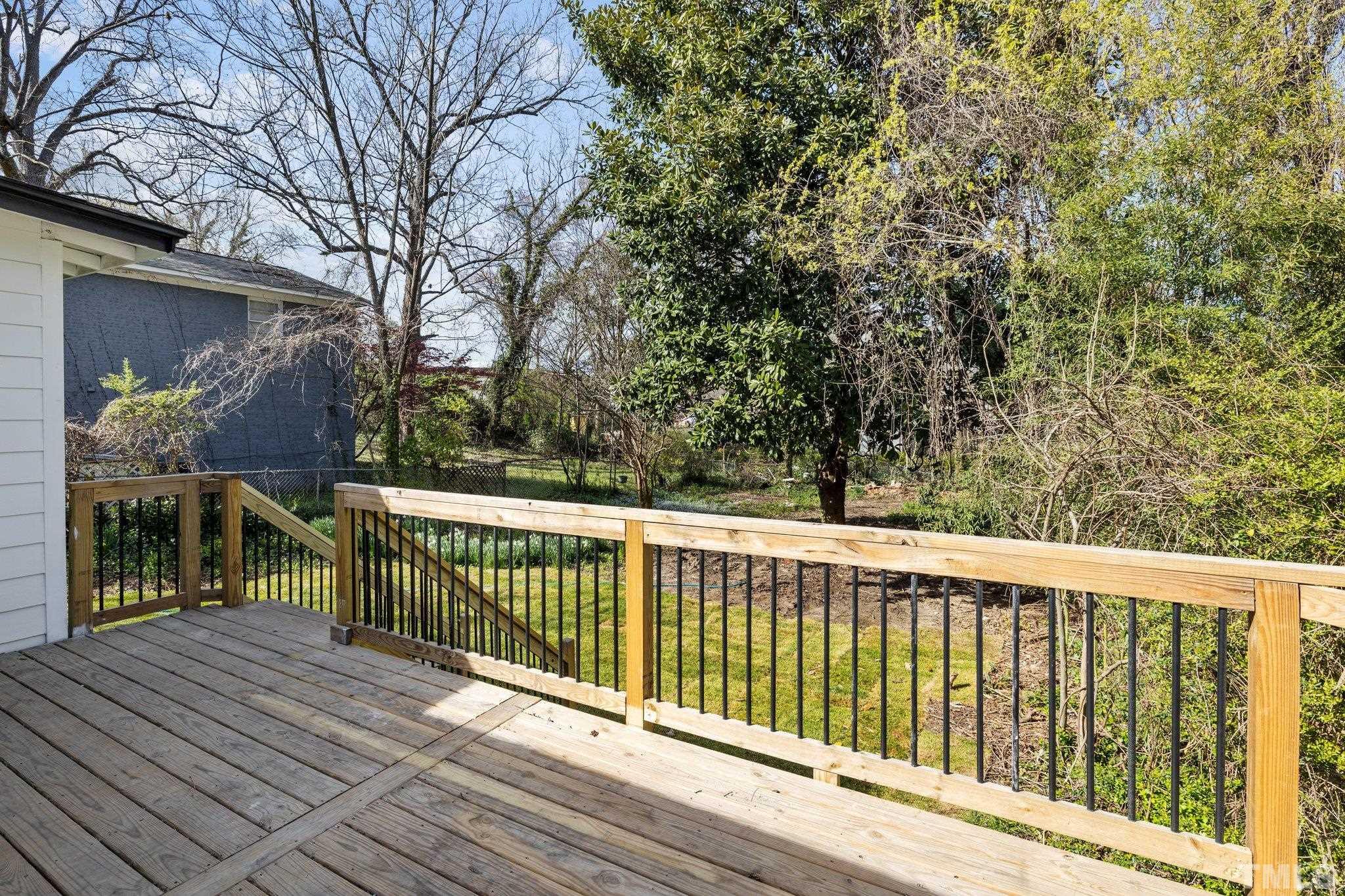 2908 Woods Place Raleigh, NC 27607 - Photo 19 of 38 a view of balcony with wooden floor and fence