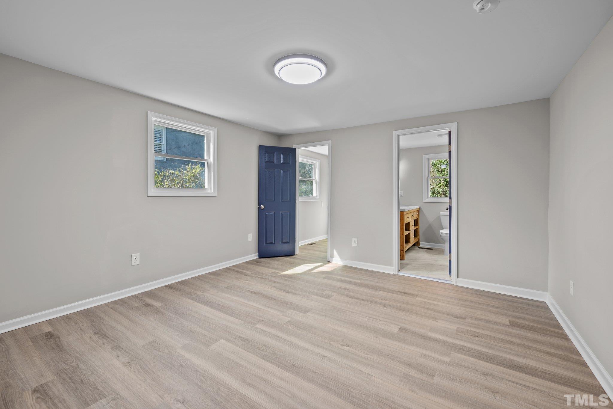 2908 Woods Place Raleigh, NC 27607 - Photo 30 of 38 a view of an empty room with wooden floor and a window