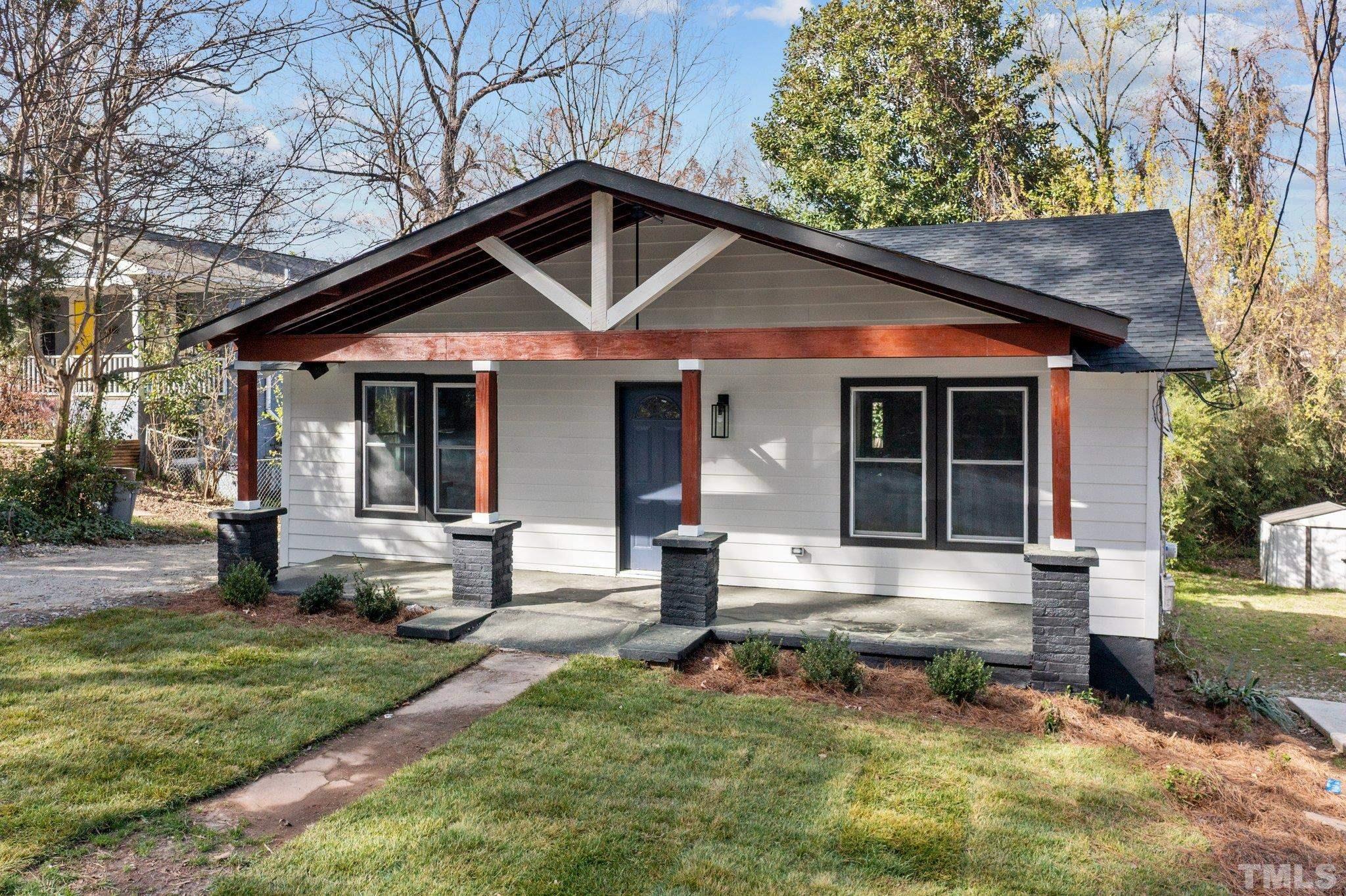2908 Woods Place Raleigh, NC 27607 - Photo 3 of 38 a front view of a house with garden