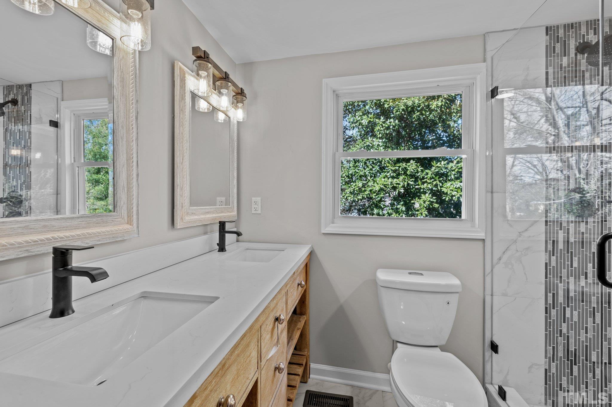 2908 Woods Place Raleigh, NC 27607 - Photo 33 of 38 a bathroom with a toilet sink and mirror