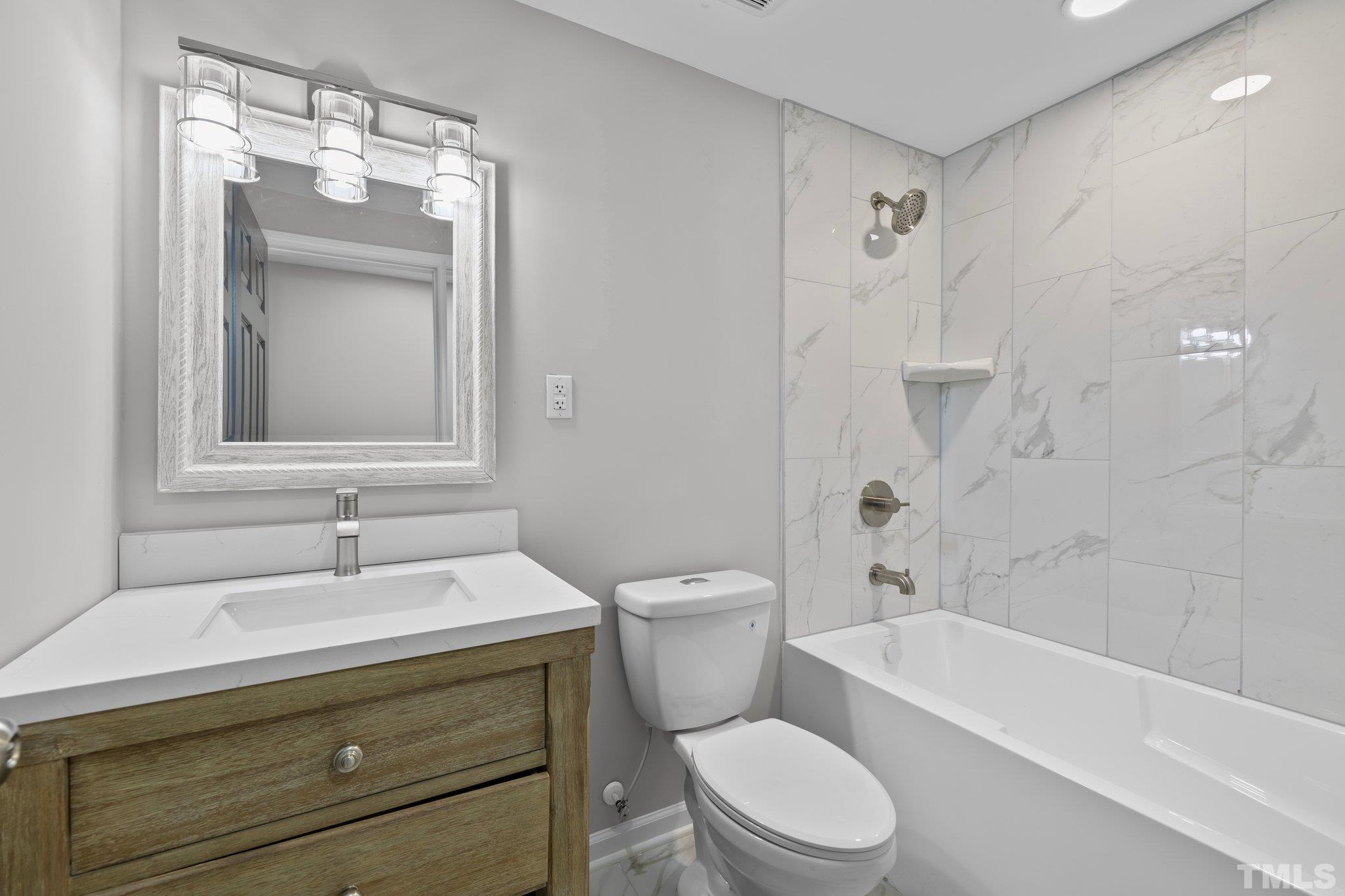 2908 Woods Place Raleigh, NC 27607 - Photo 38 of 38 a bathroom with a sink toilet and shower