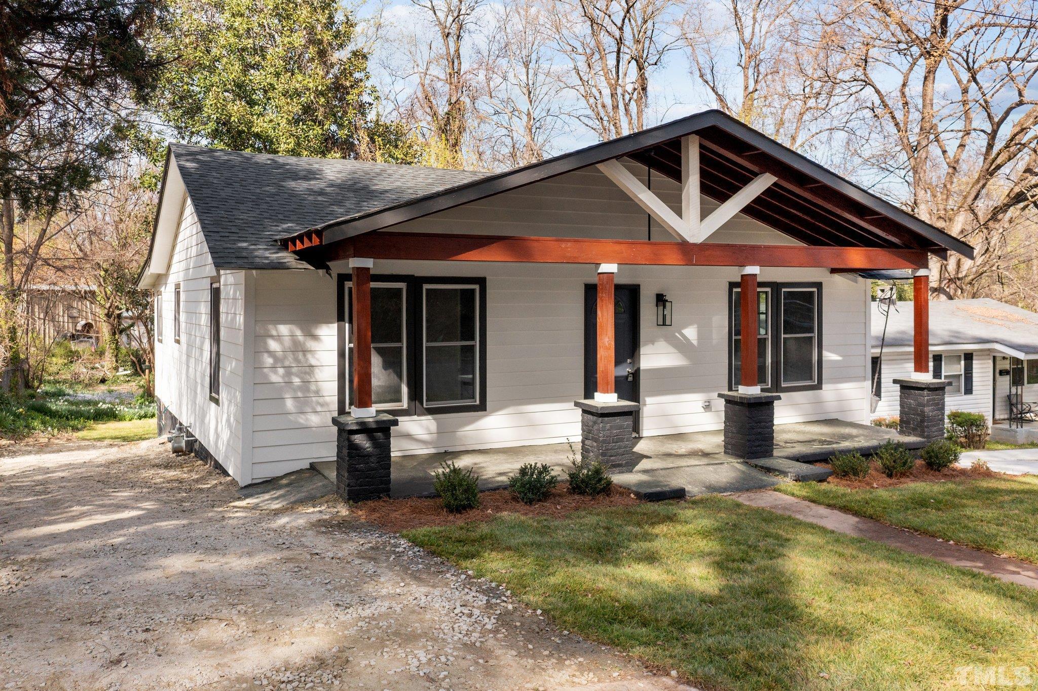 2908 Woods Place Raleigh, NC 27607 - Photo 4 of 38 a front view of a house with garden