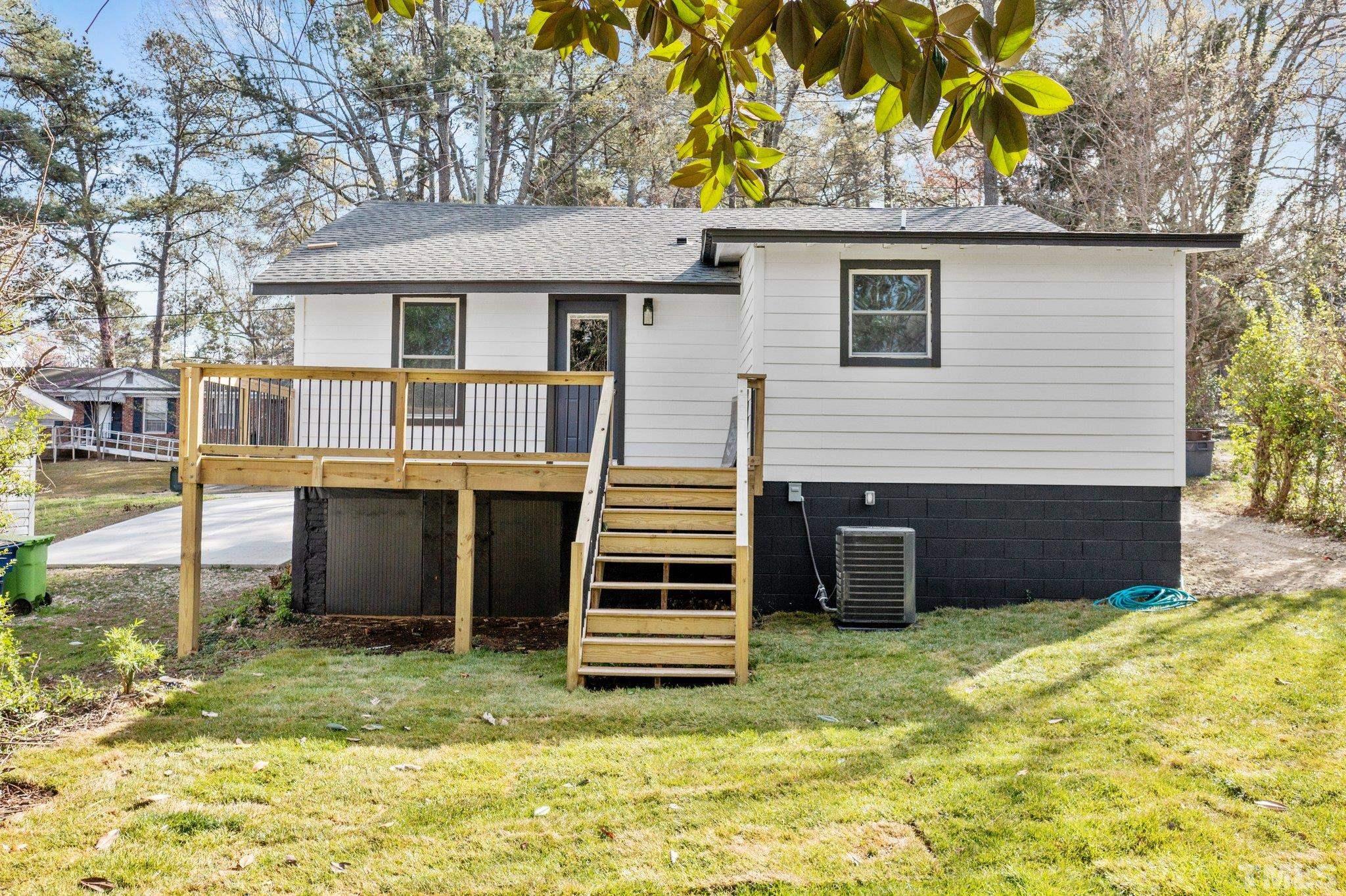 2908 Woods Place Raleigh, NC 27607 - Photo 9 of 38 a view of a house with a yard and garage