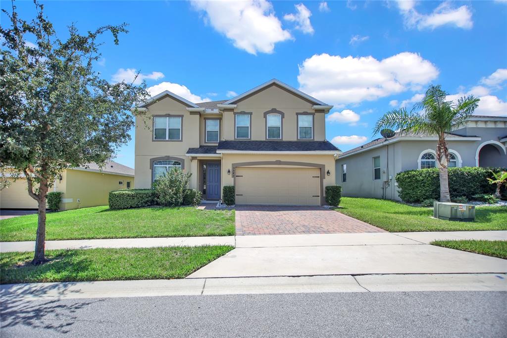 a front view of a house with a yard and garage