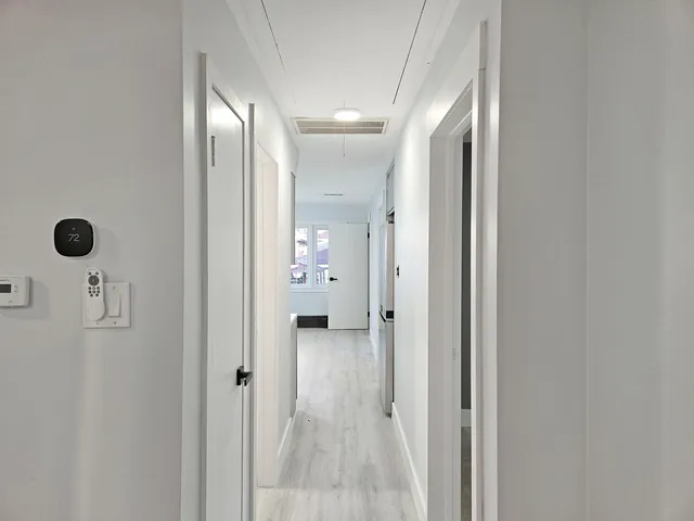 a view of walk in closet with empty racks
