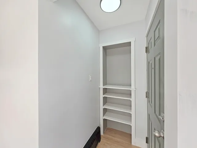 a view of an empty room with a window