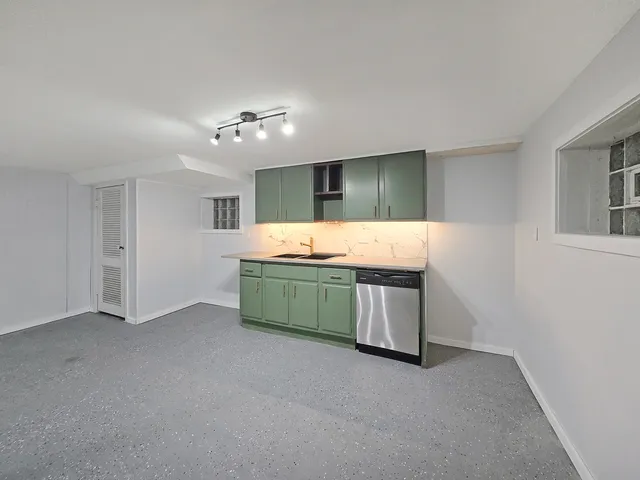 a kitchen with sink and cabinets