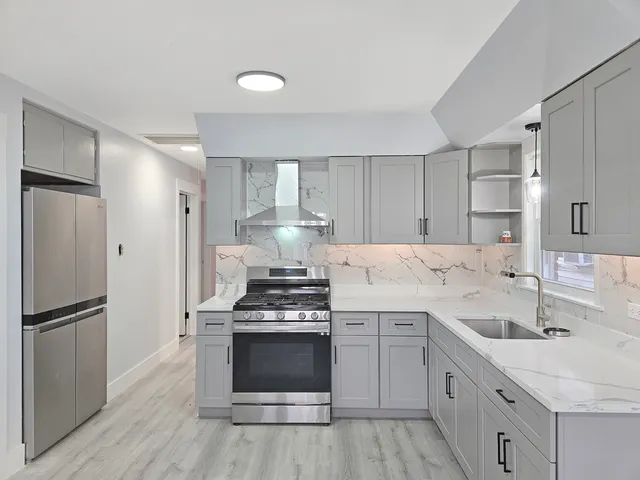 a kitchen with a stove sink and refrigerator