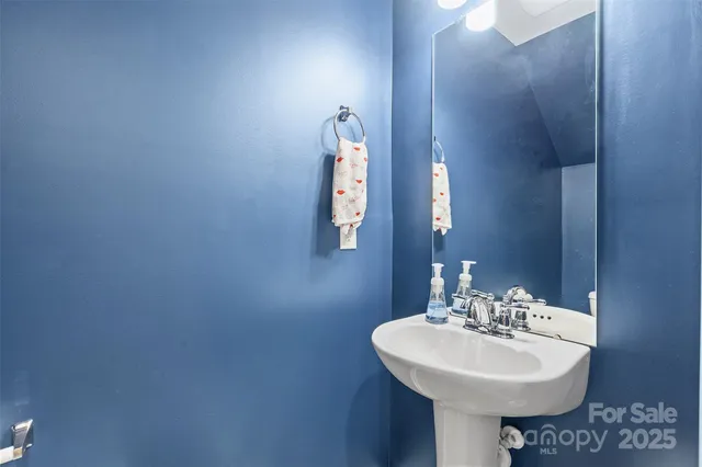 a bathroom with a sink a mirror and vanity