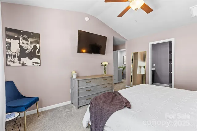 a bed room with a bed and a television