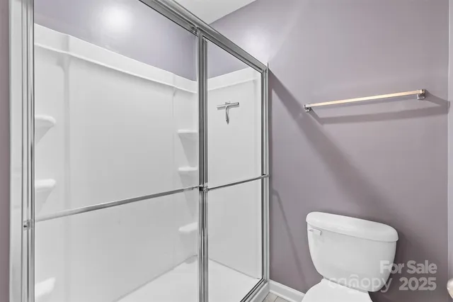 a bathroom with a toilet and a shower