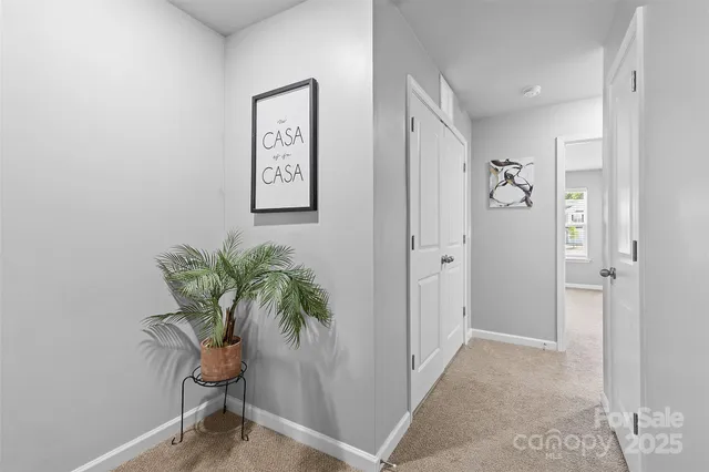 a view of a hallway with paintings on the wall