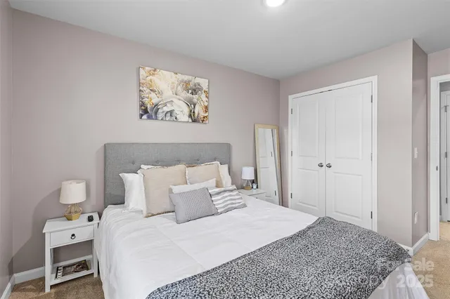 a bedroom with a bed and a couch