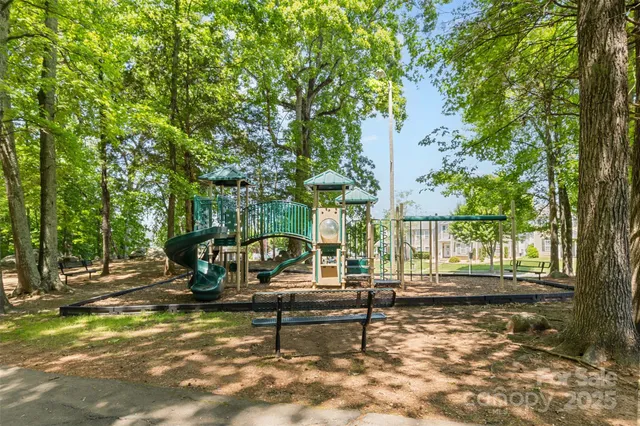 a backyard of a house with barbeque oven table and chairs