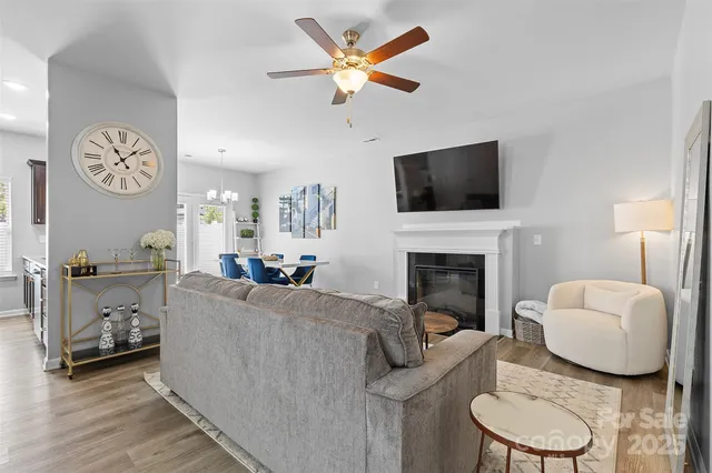 a living room with furniture a fireplace and a flat screen tv