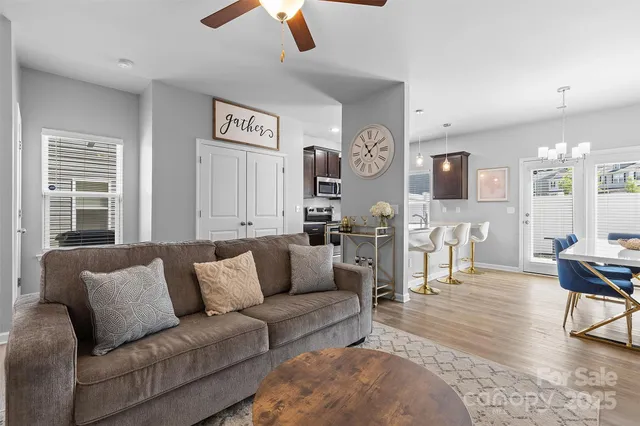 a living room with furniture and a chandelier