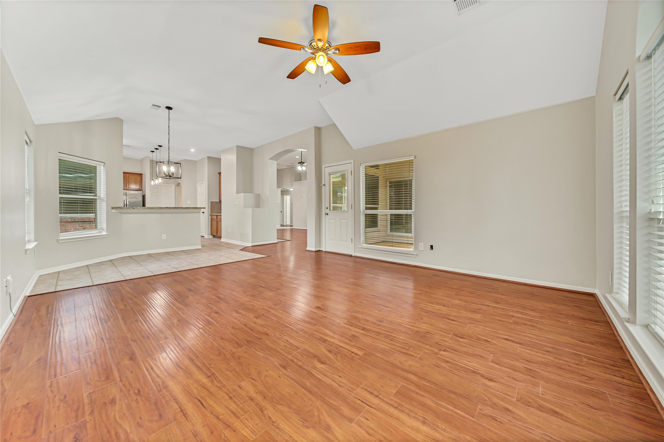 14526 Red Tailed Hawk Lane Houston, TX 77044 - Photo 17 of 40 a view of a kitchen with wooden floor and a ceiling fan