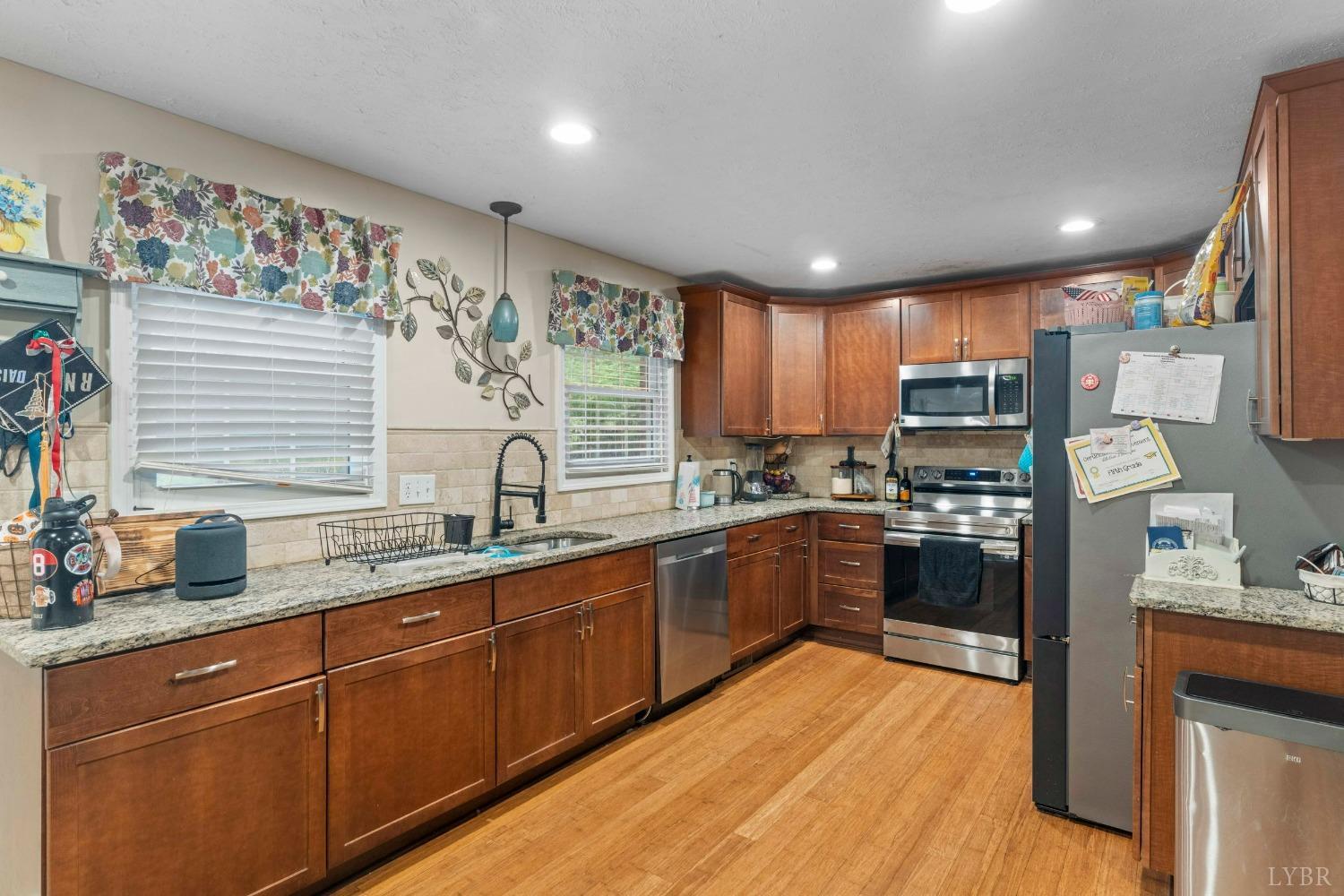 858 Farfields Drive Lynchburg, VA 24502 - Photo 12 of 61 a kitchen with stainless steel appliances granite countertop sink stove top oven and cabinets