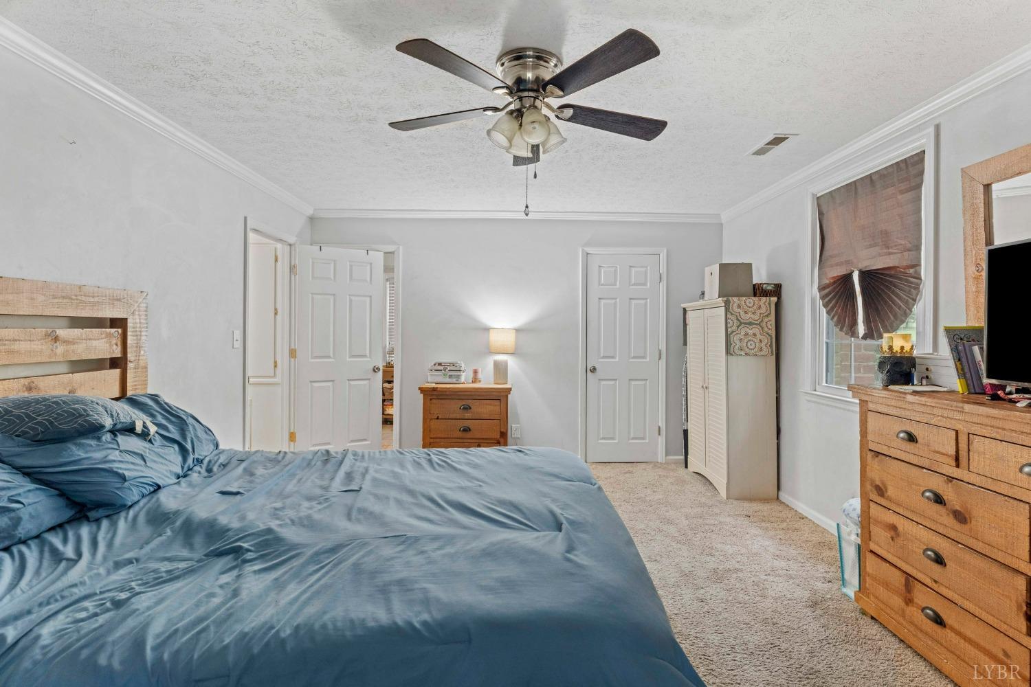 858 Farfields Drive Lynchburg, VA 24502 - Photo 15 of 61 a spacious bedroom with a bed and a chandelier