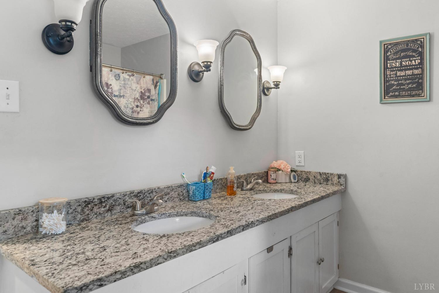 858 Farfields Drive Lynchburg, VA 24502 - Photo 18 of 61 a bathroom with a granite countertop sink and a mirror
