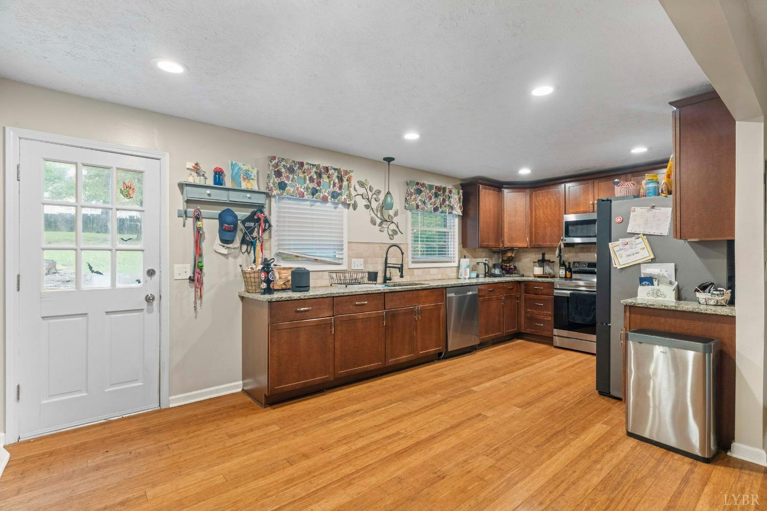 858 Farfields Drive Lynchburg, VA 24502 - Photo 9 of 61 a kitchen with granite countertop a refrigerator and wooden floors