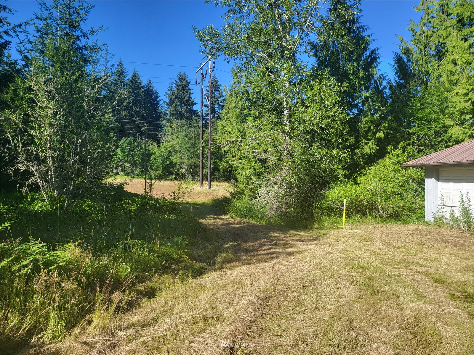 377 South Eldridge Road Sequim, WA 98382 - Photo 16 of 20 a backyard of a house with a yard and outdoor seating