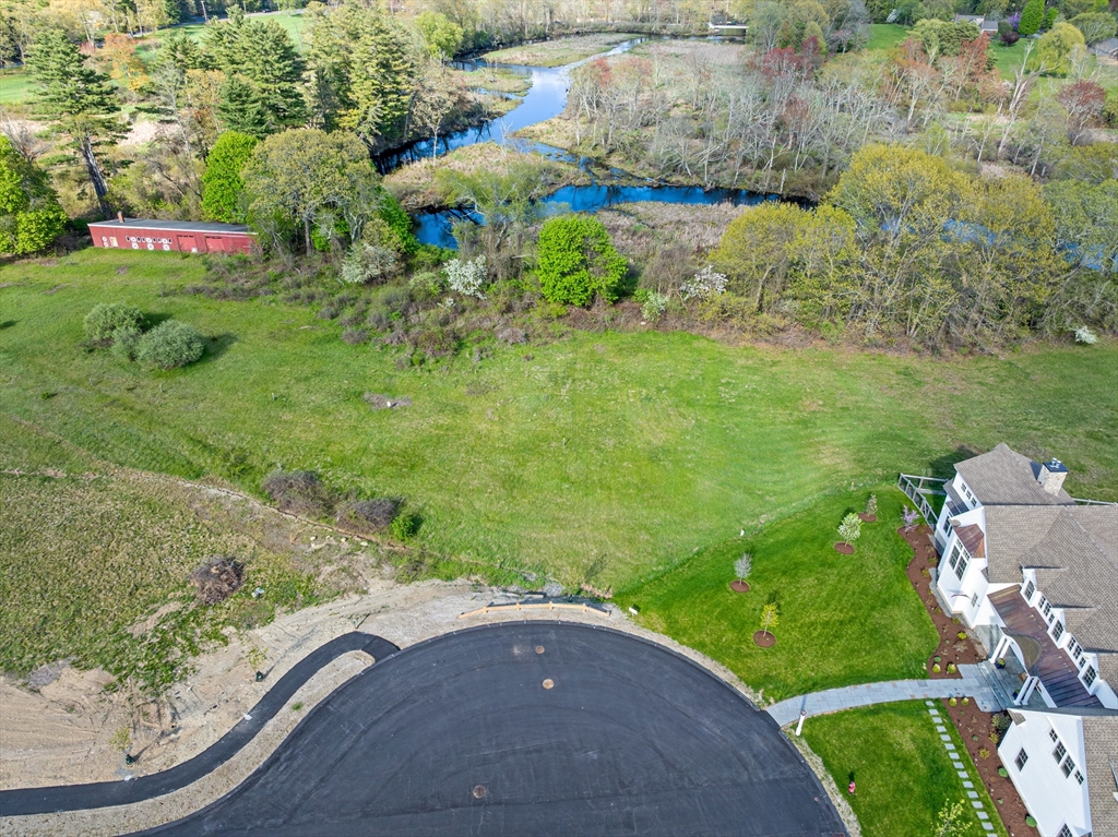 8 Pearl Way Topsfield, MA 01983 - Photo 6 of 9 a backyard of a house with a yard and lake