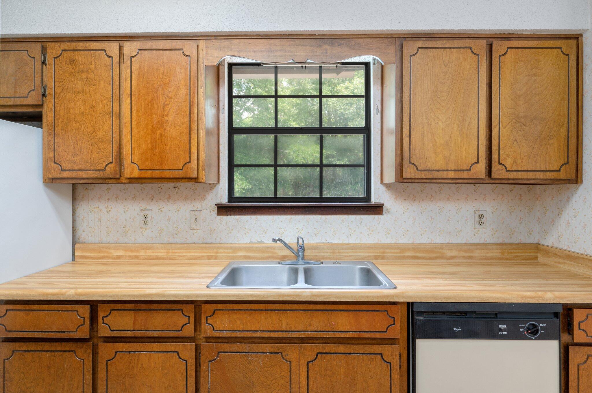 6141 Bud Moulton Road Crestview, FL 32536 - Photo 12 of 34 a kitchen with stainless steel appliances granite countertop a sink and a cabinets