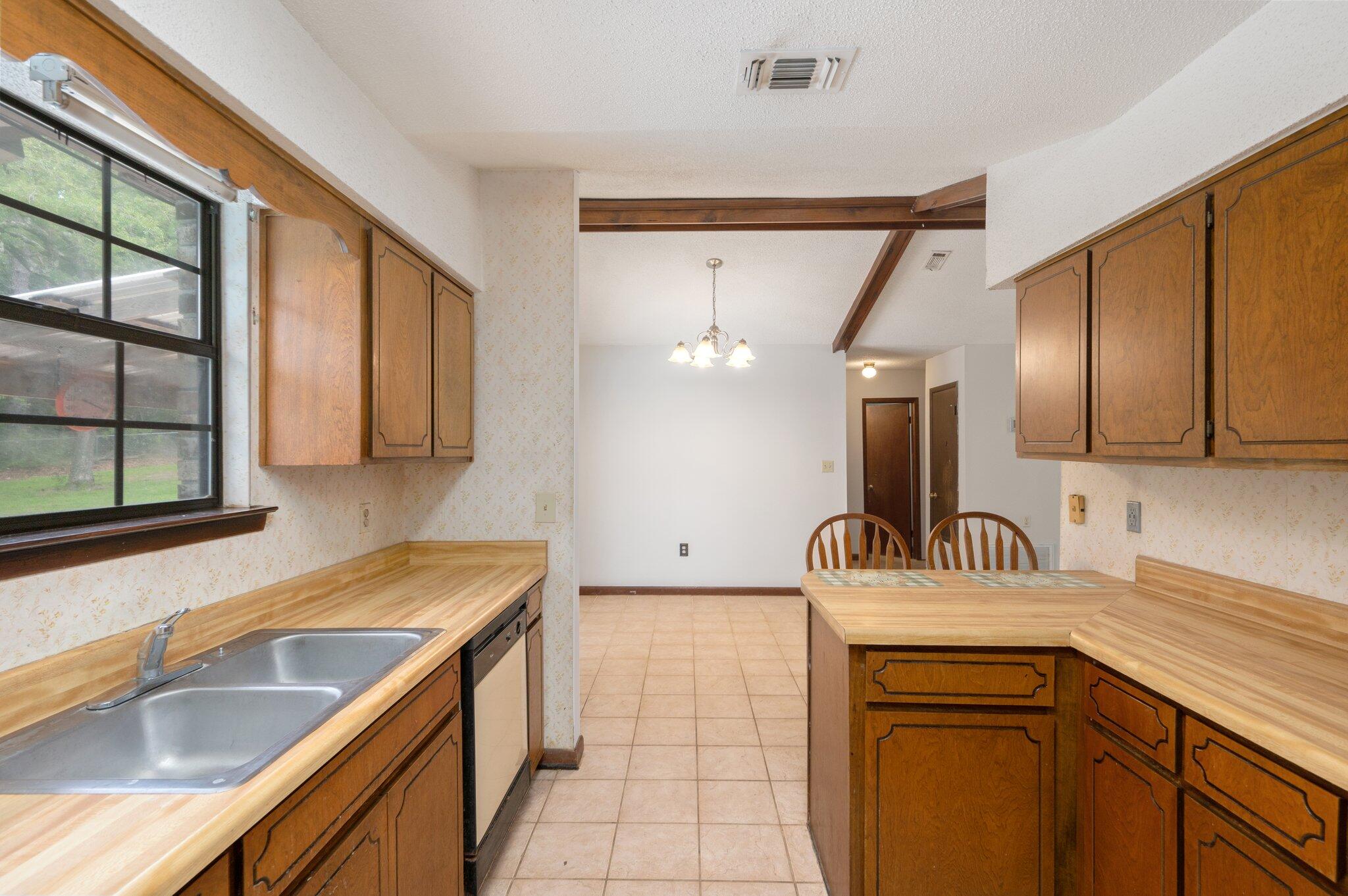 6141 Bud Moulton Road Crestview, FL 32536 - Photo 14 of 34 a kitchen with a sink and a refrigerator