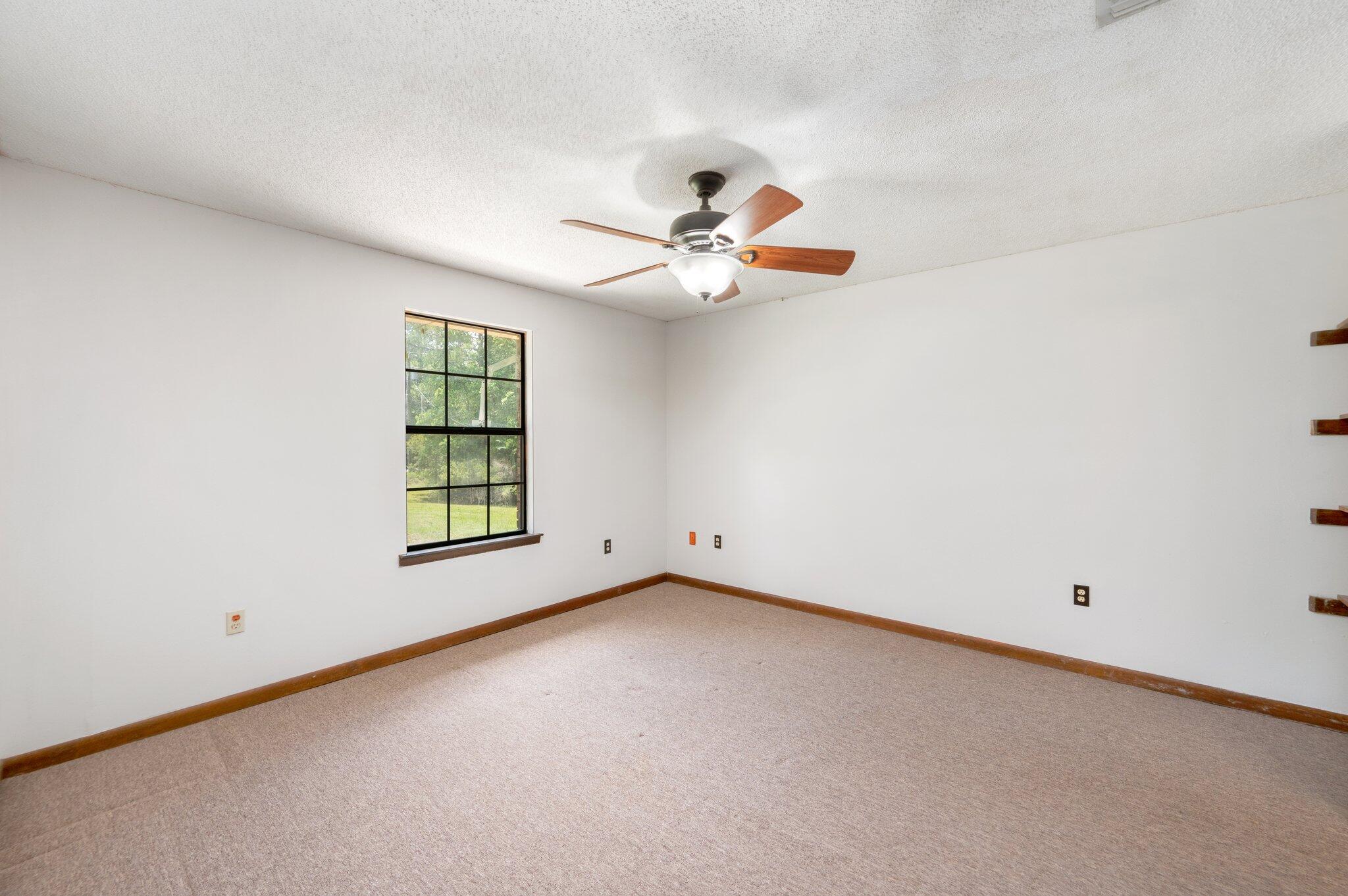 6141 Bud Moulton Road Crestview, FL 32536 - Photo 15 of 34 an empty room with windows and fan