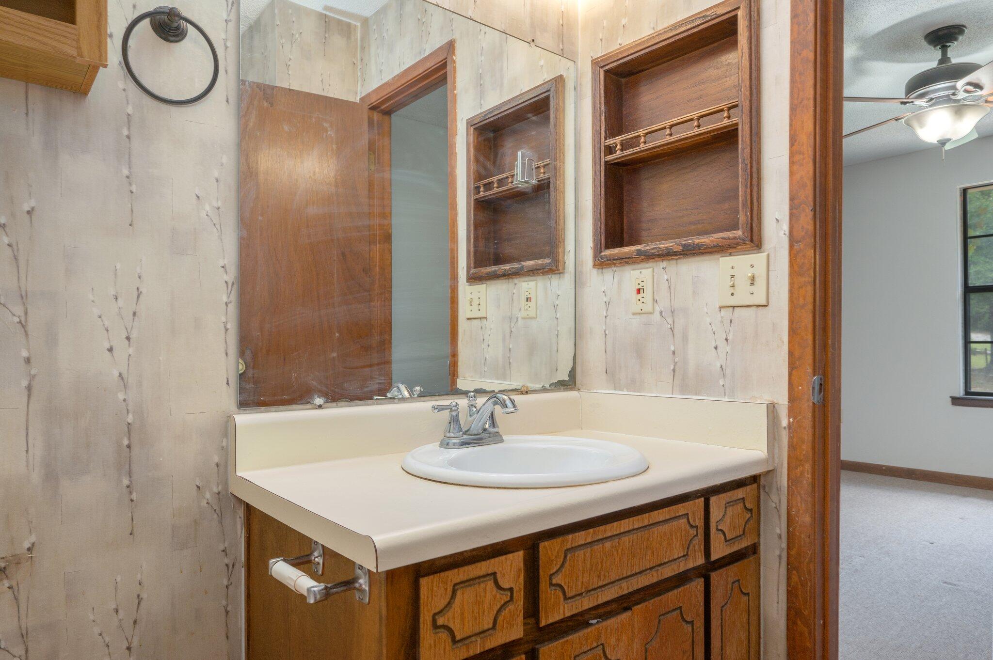 6141 Bud Moulton Road Crestview, FL 32536 - Photo 18 of 34 a bathroom with a sink and a mirror