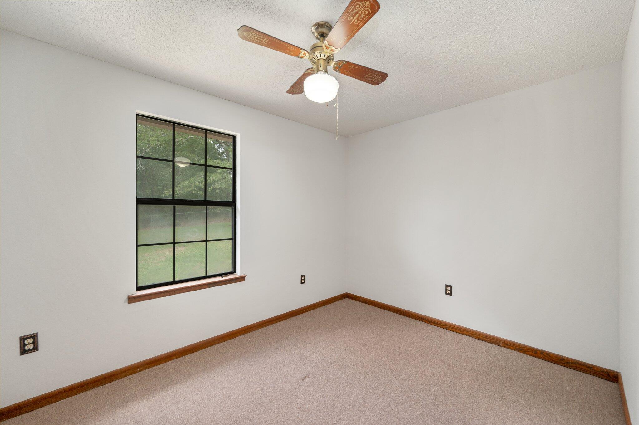 6141 Bud Moulton Road Crestview, FL 32536 - Photo 20 of 34 an empty room with a window and ceiling fan