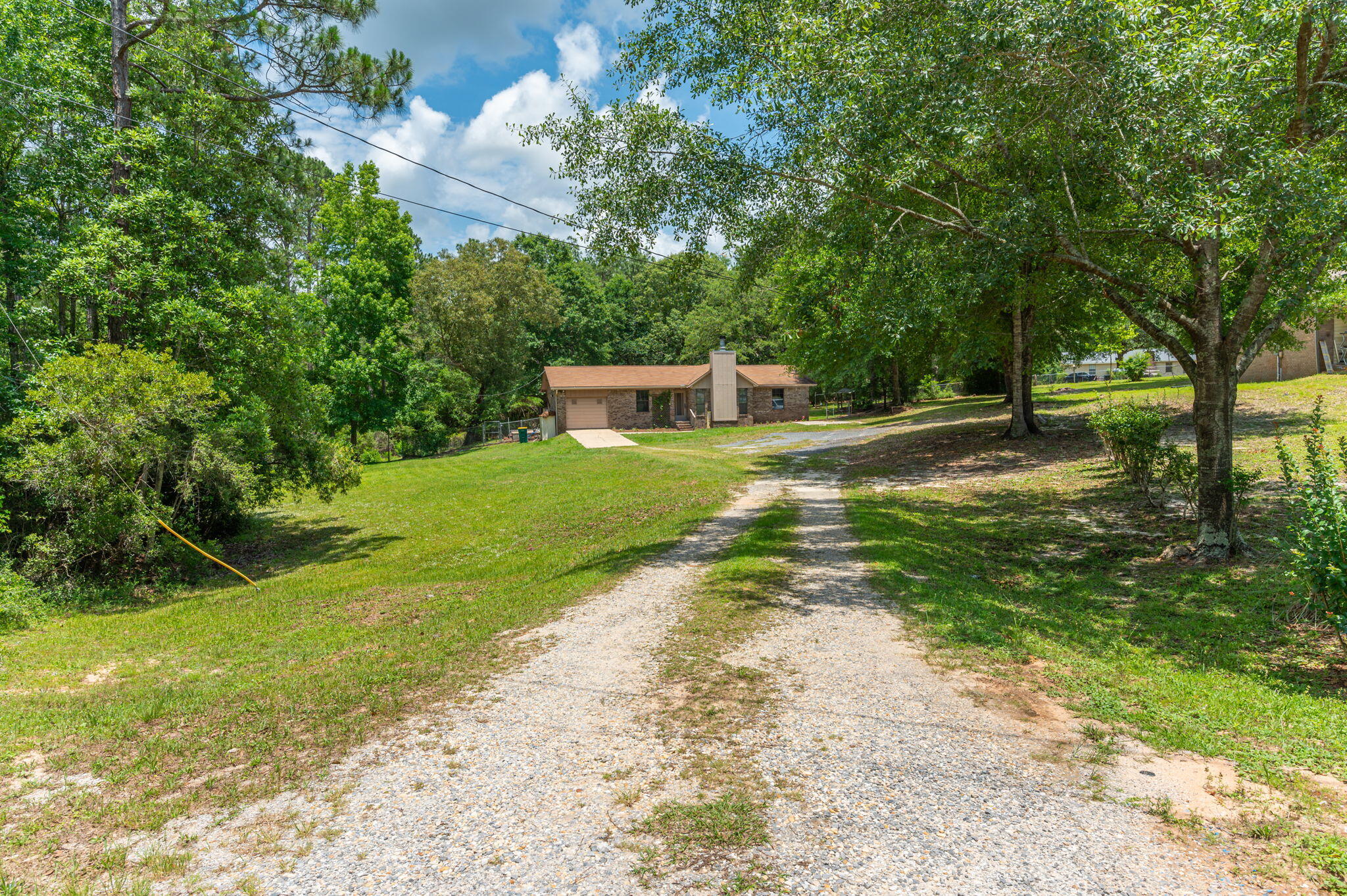 6141 Bud Moulton Road Crestview, FL 32536 - Photo 2 of 34 a view of a yard with plants and trees