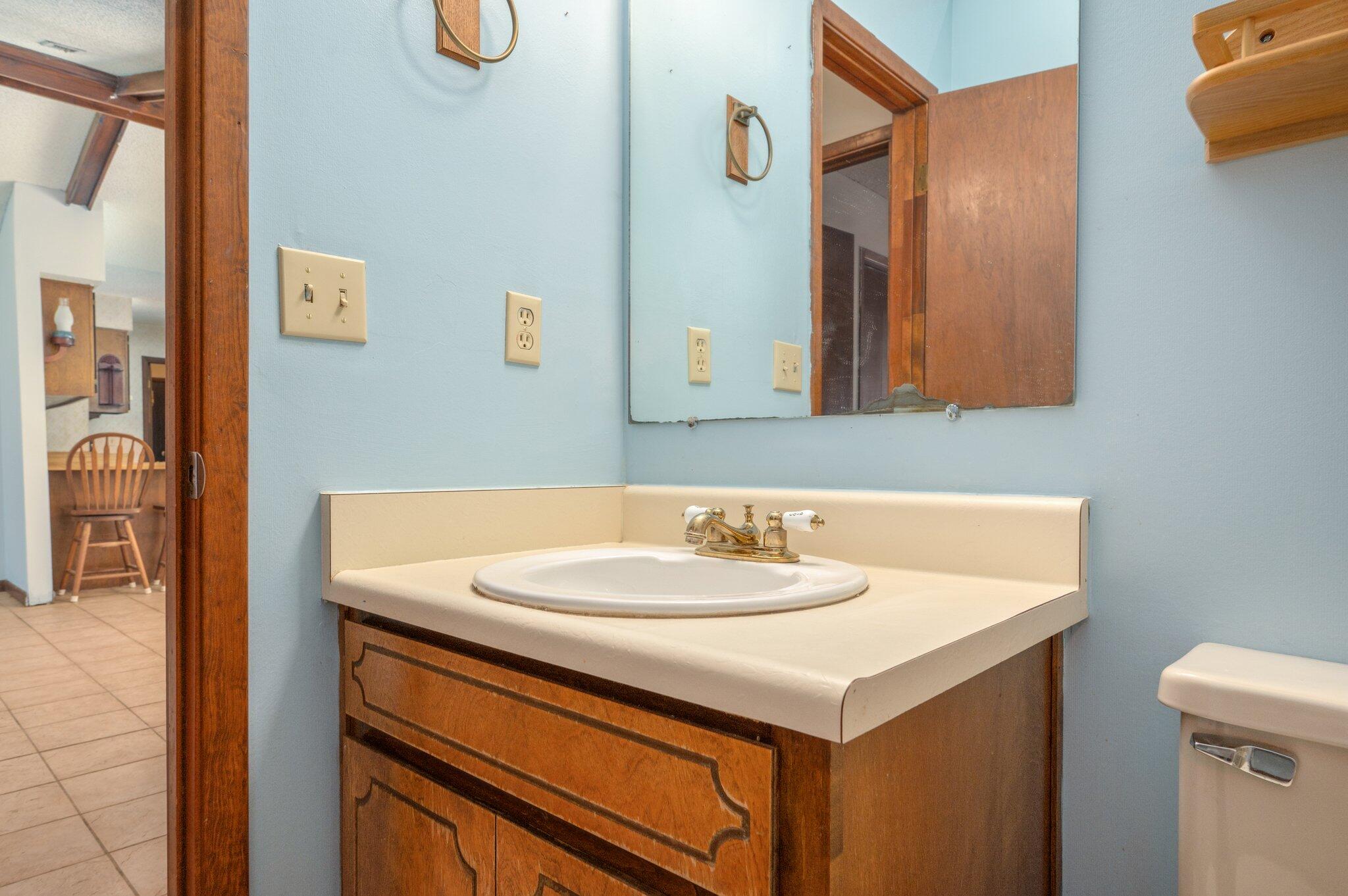 6141 Bud Moulton Road Crestview, FL 32536 - Photo 25 of 34 a bathroom with a sink and a mirror