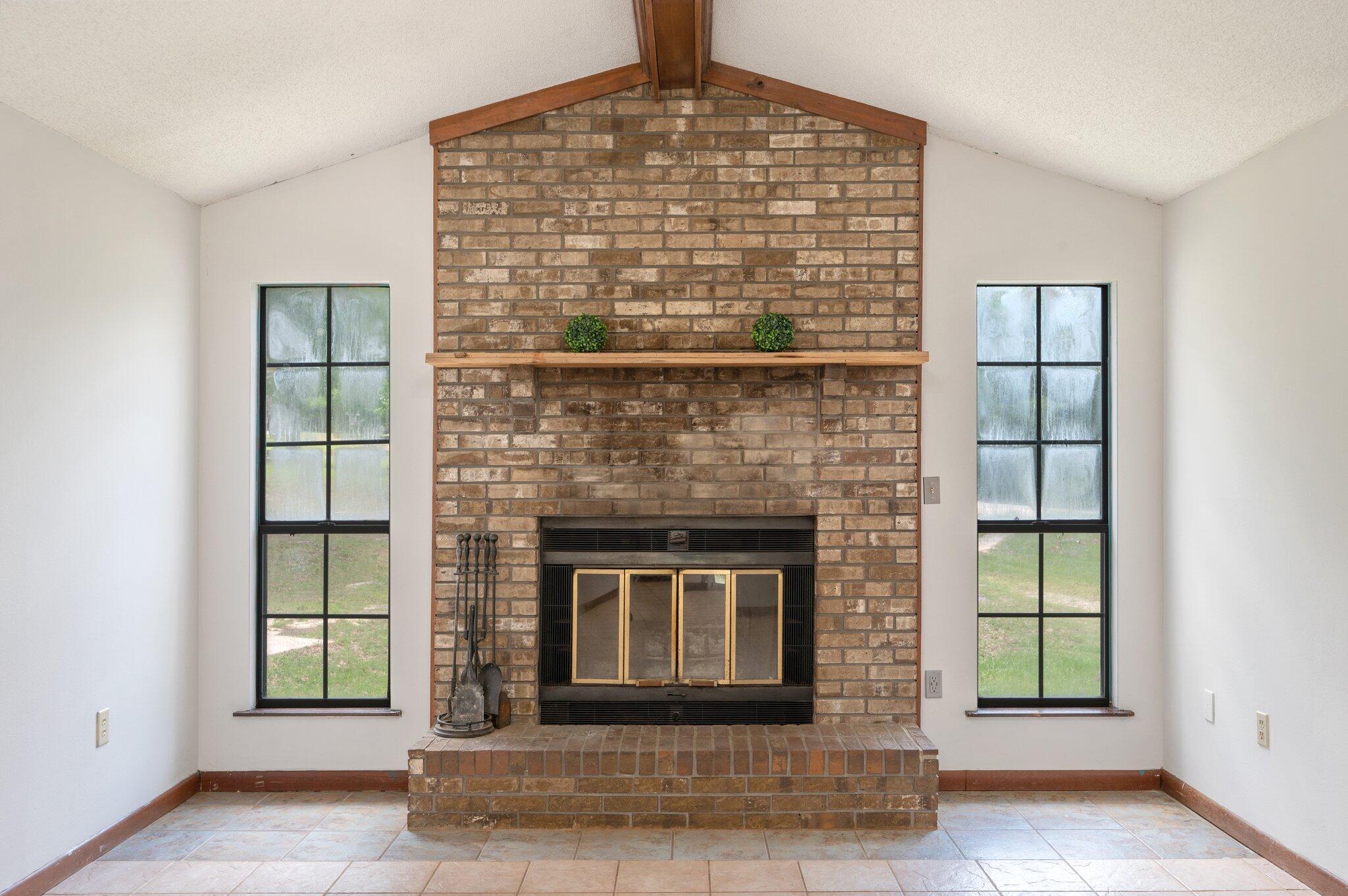 6141 Bud Moulton Road Crestview, FL 32536 - Photo 7 of 34 a living room with a fireplace and a window