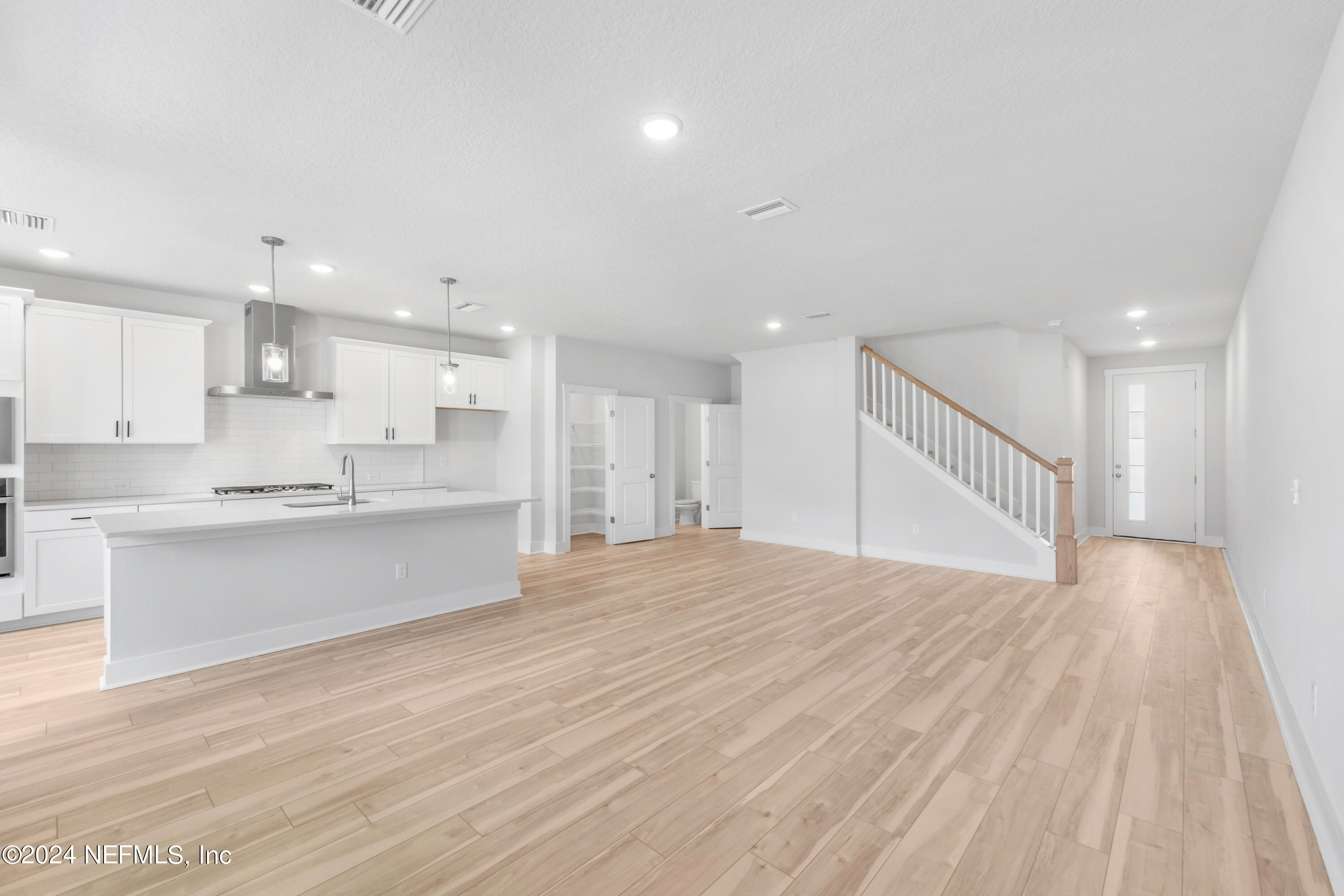 9828 Element Road Jacksonville, FL 32256 - Photo 9 of 17 a view of kitchen with kitchen island sink and wooden floor