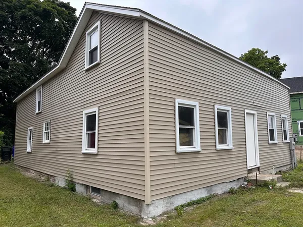 a view of a house with a yard and garage