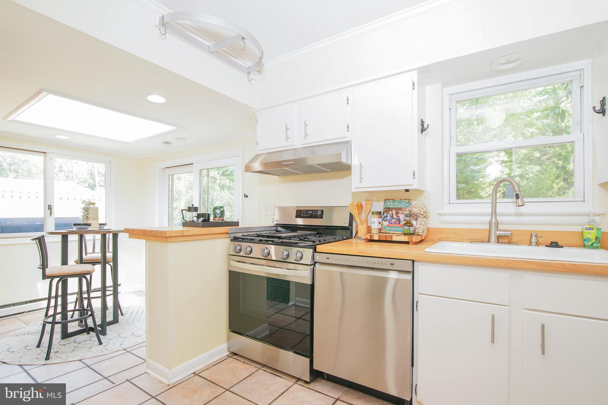 5602 Hawthorne Street Capitol Heights, MD 20743 - Photo 13 of 68 a kitchen with a stove a sink and a refrigerator