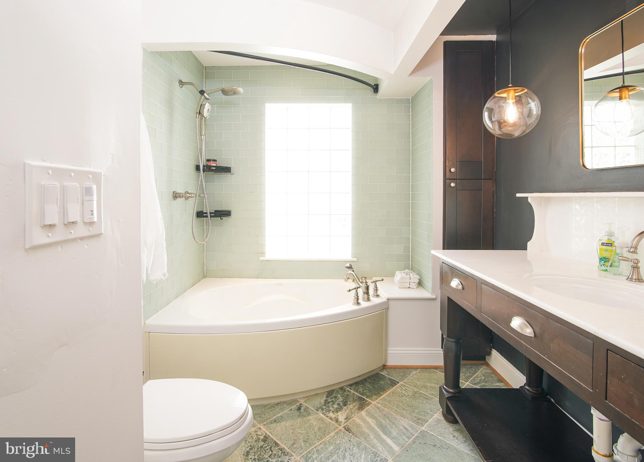 5602 Hawthorne Street Capitol Heights, MD 20743 - Photo 26 of 68 a bathroom with a toilet a sink and bathtub