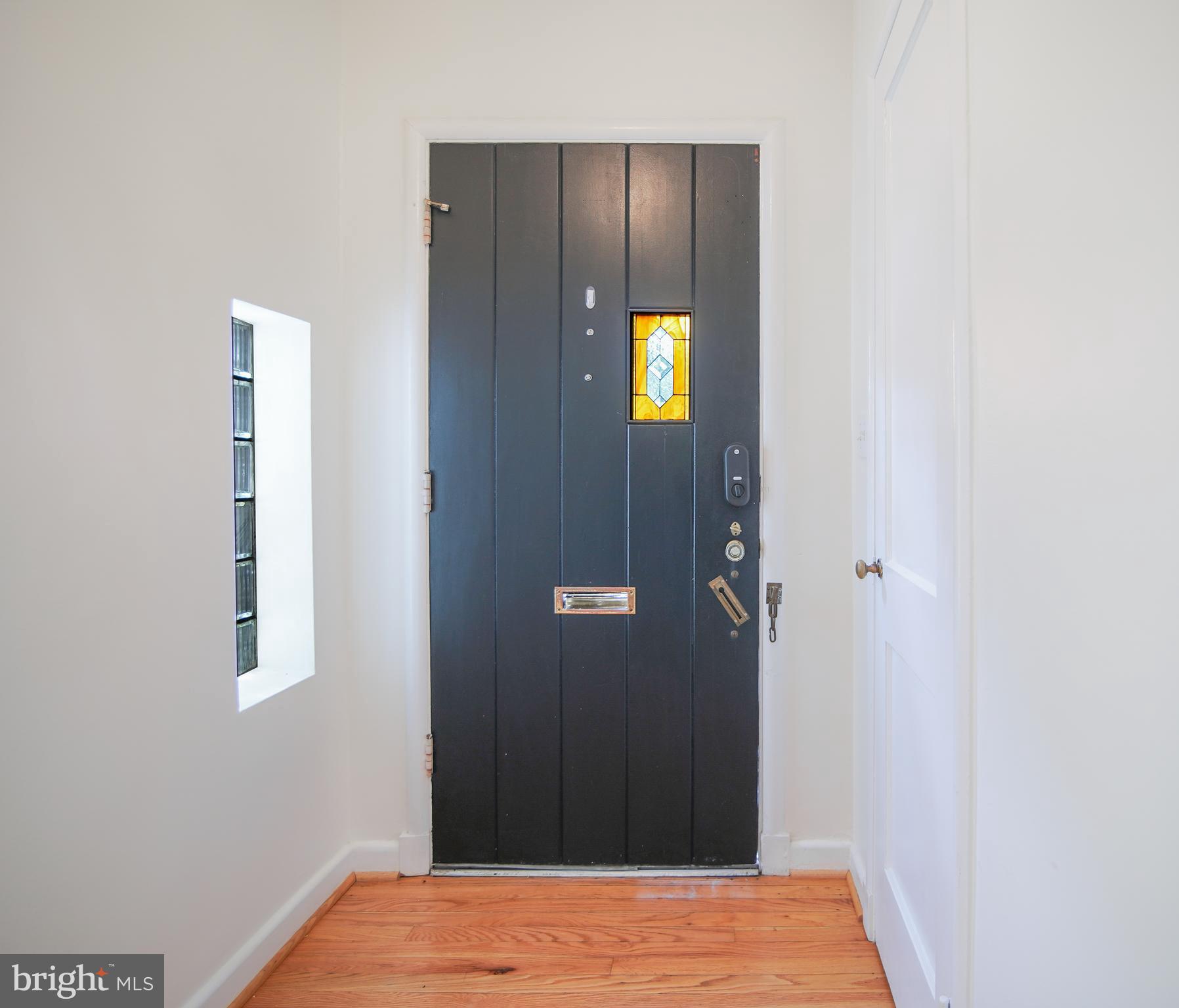 5602 Hawthorne Street Capitol Heights, MD 20743 - Photo 3 of 68 a view of a hallway with wooden floor and a bathroom