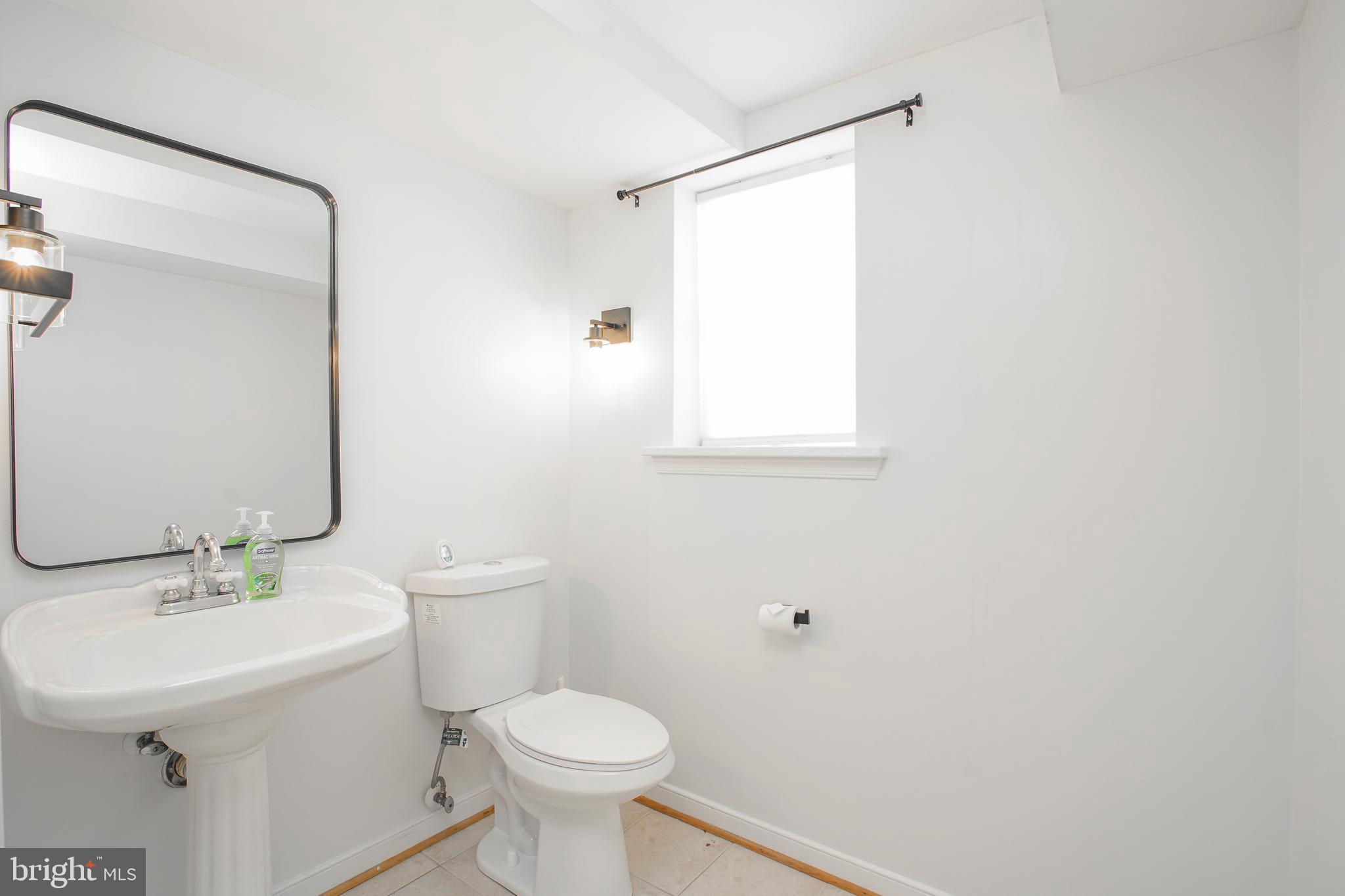 5602 Hawthorne Street Capitol Heights, MD 20743 - Photo 33 of 68 a bathroom with a sink toilet and a mirror