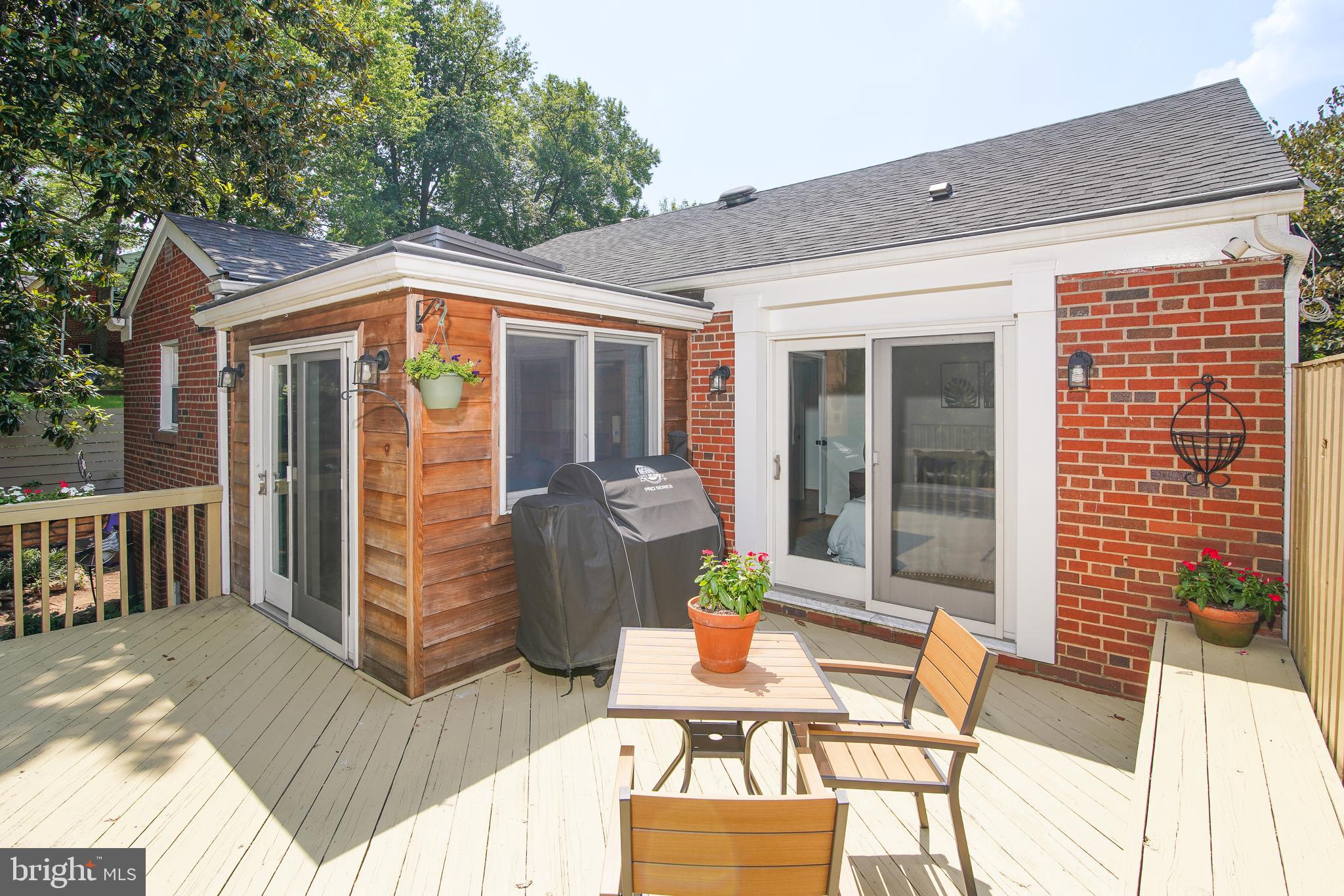 5602 Hawthorne Street Capitol Heights, MD 20743 - Photo 37 of 68 a view of a patio with table and chairs and wooden floor