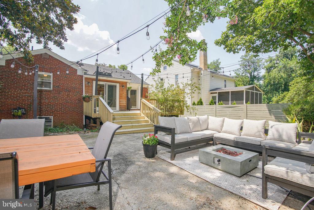 5602 Hawthorne Street Capitol Heights, MD 20743 - Photo 59 of 68 a view of a patio with couches table and chairs with wooden floor and fence